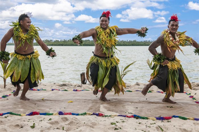 Traditional dancers performing on a beach