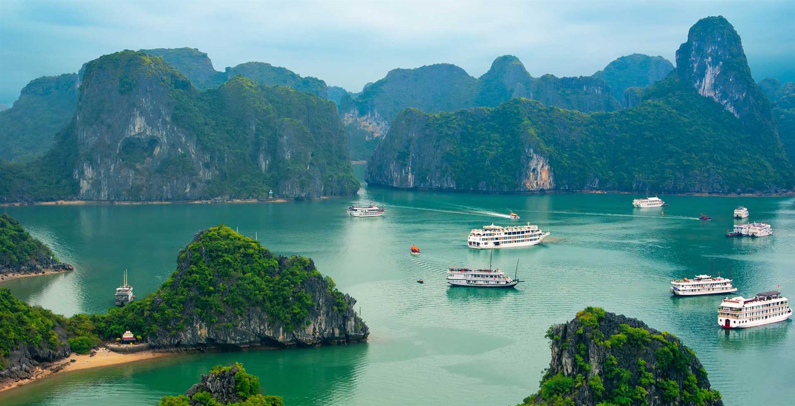 Limestone islands and tour boats in Ha Long Bay, Vietnam