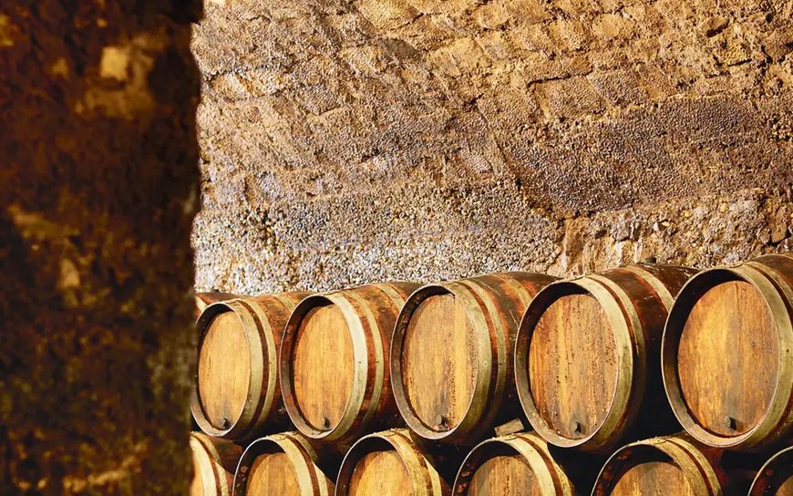 Oak wine barrels in a stone cellar